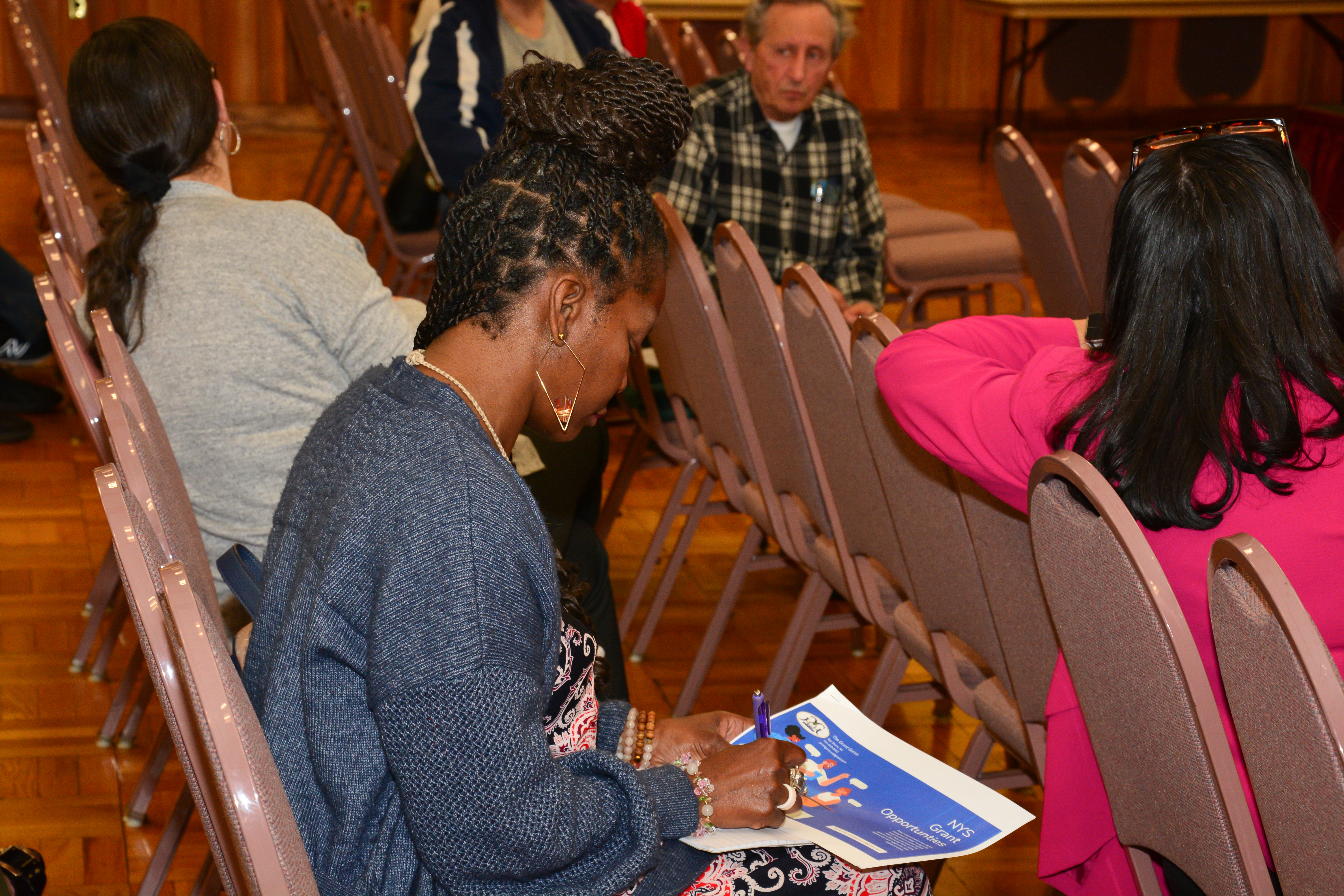 Participants of a grant writing workshop sponsored by NYS Senator Monica R. Martinez receive information about the state grant process.