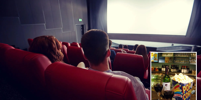 Audience watching a movie in a movie theater. 