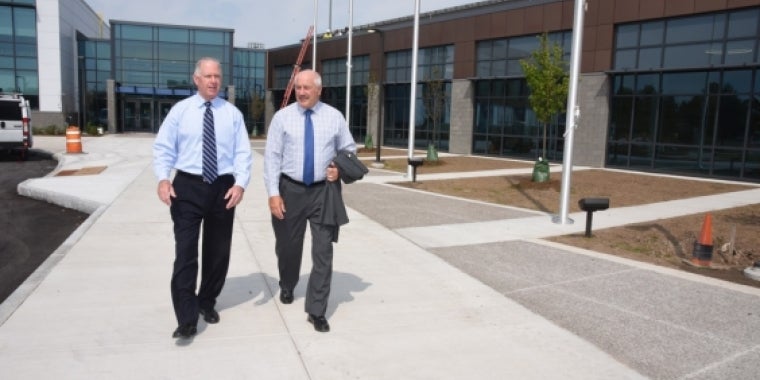 Senator Ranzenhofer and President Sunser walk outside the new Richard C. Call Arena.