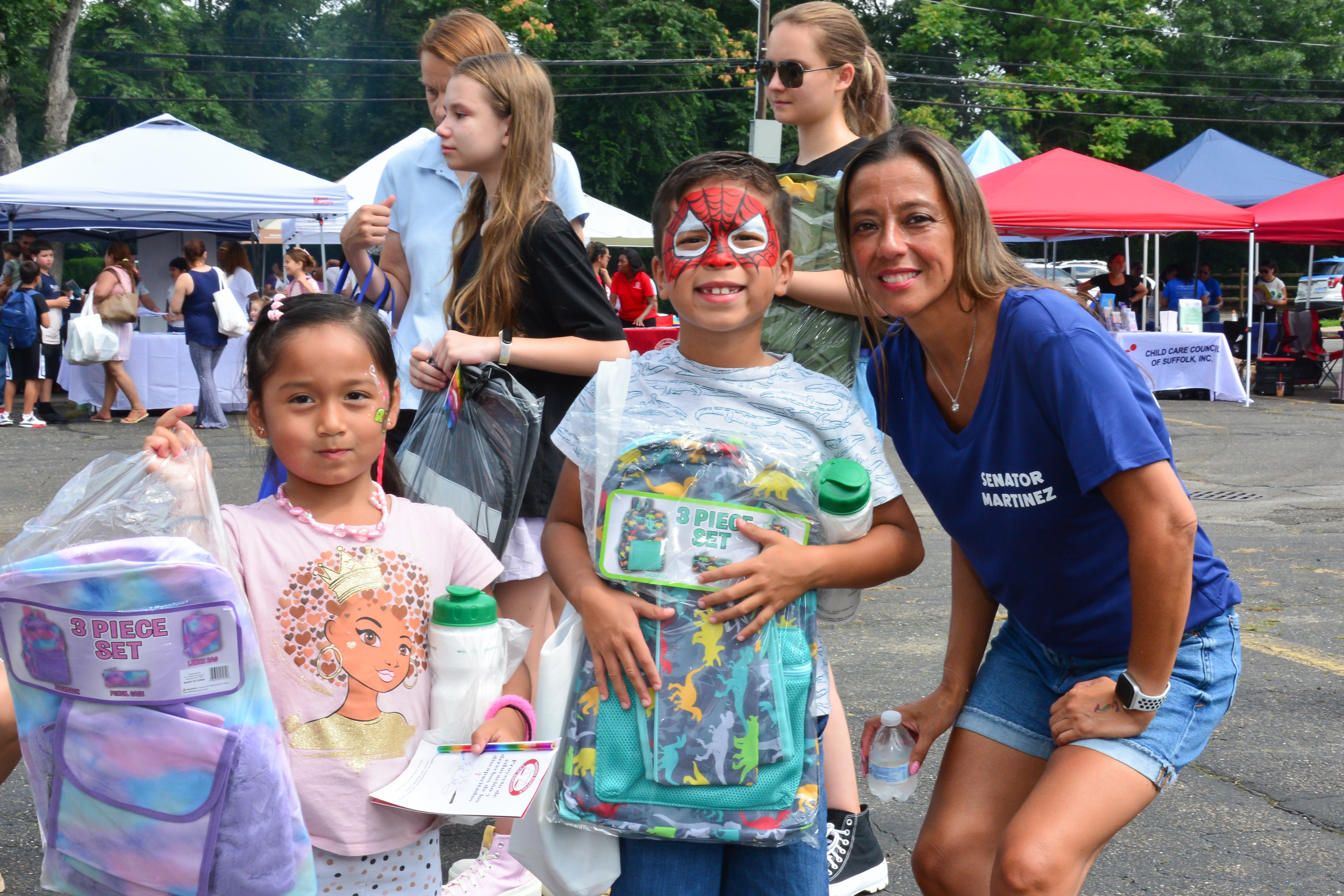 New York State Sen. Monica R. Martinez poses for a photo with children who attended a back-to-school backpack and supply drive distribution event in Brentwood on Saturday, August 10, 2024. 