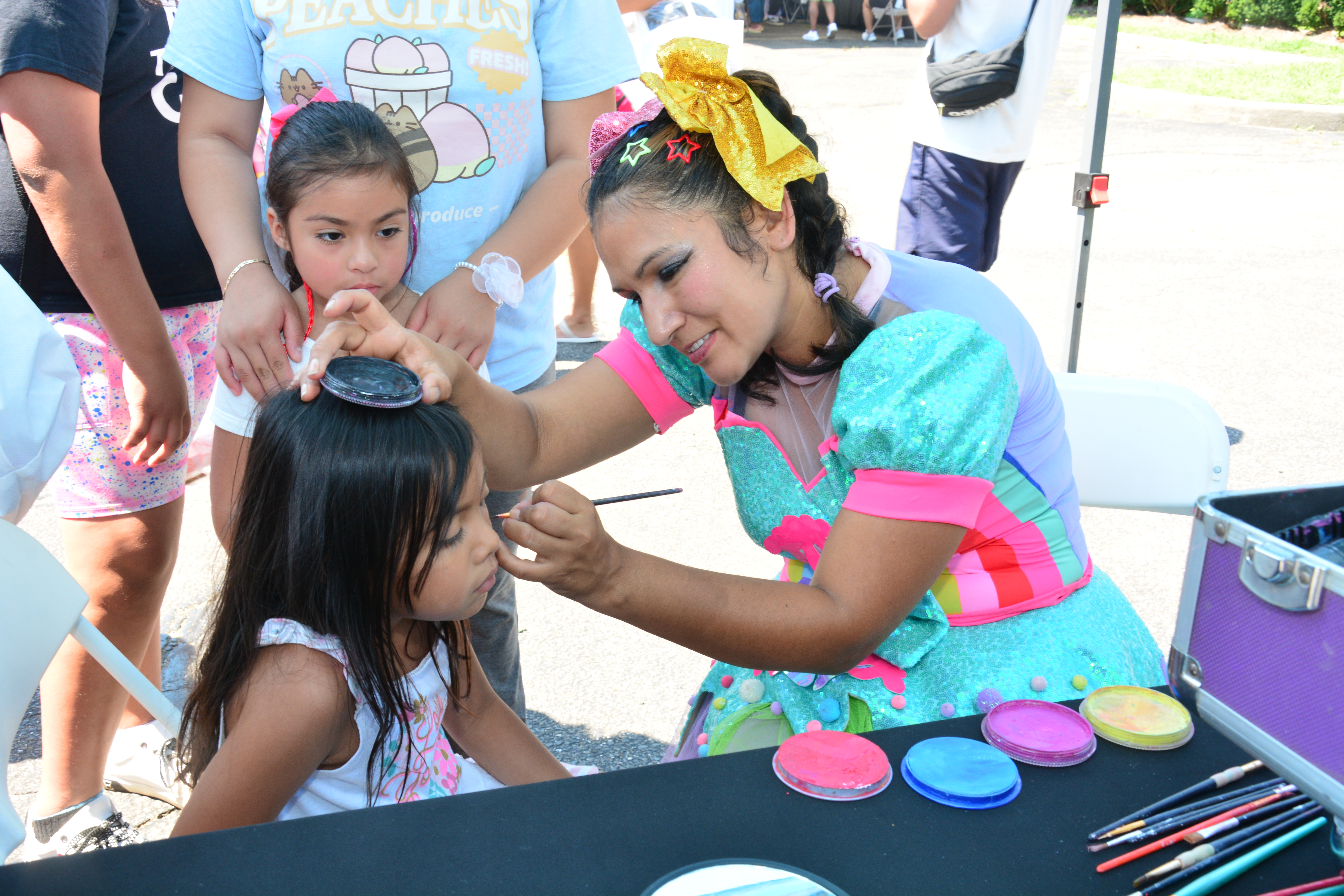 A child who attended New York State Sen. Monica R. Martinez's back-to-school backpack and supply drive distribution event in Brentwood has her face painted.