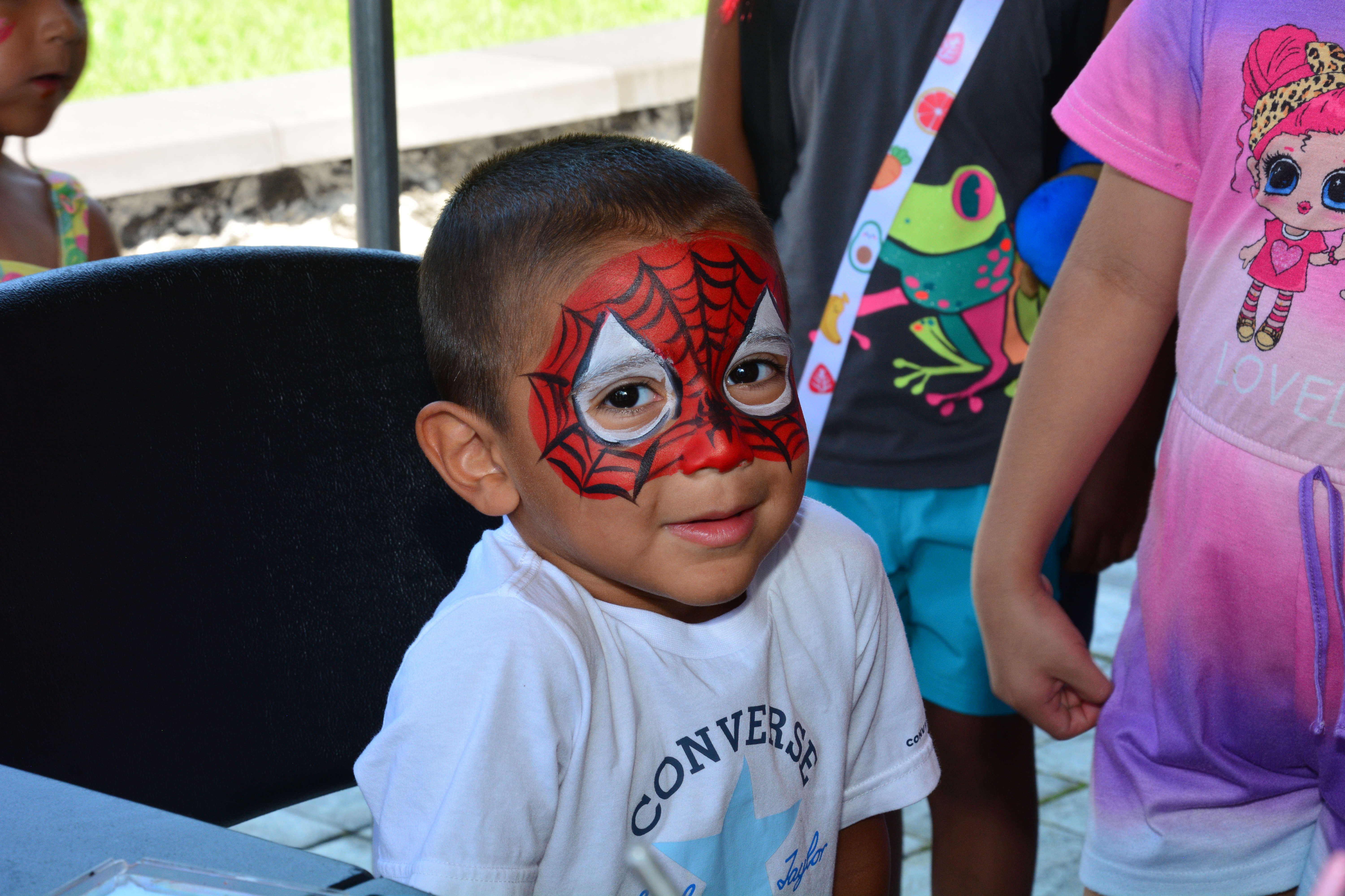 A child who attended New York State Sen. Monica R. Martinez's back-to-school backpack and supply drive distribution event in Brentwood poses for a photo after having his face painted.