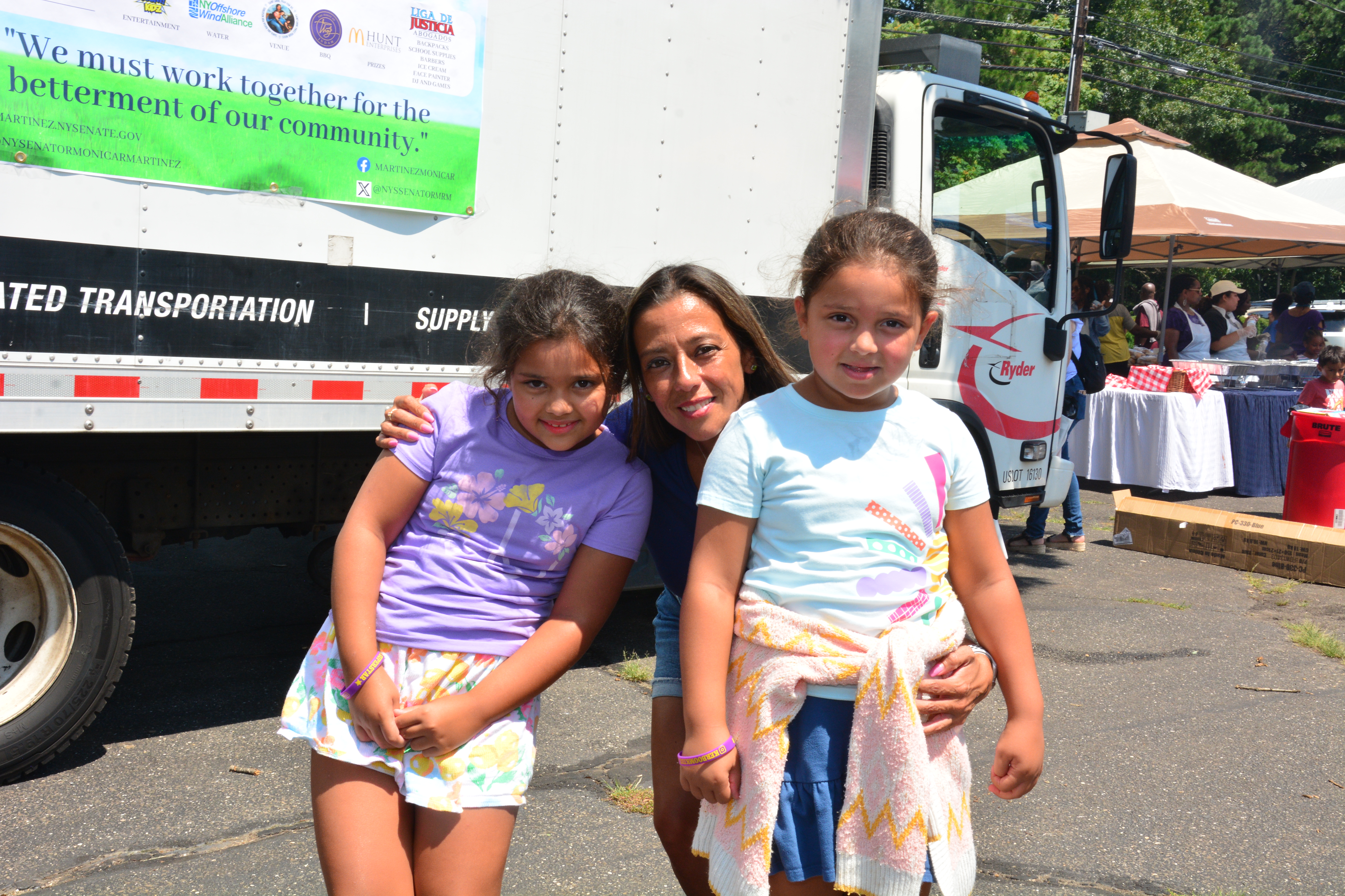 New York State Sen. Monica R. Martinez poses for a photo with children who attended a back-to-school backpack and supply drive distribution event in Brentwood on Saturday, August 10, 2024. 