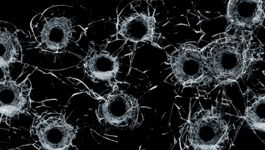 Bullet holes through glass.