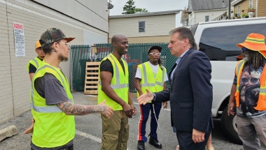 Senator Addabbo shakes hands with the CEO cleaning crew.
