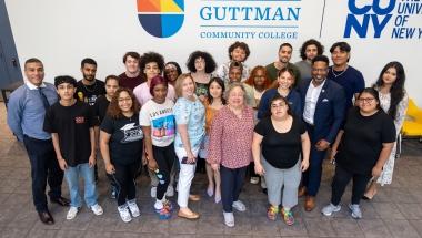 Senator Krueger stands with students from Guttman Community College