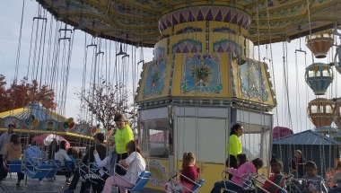 Photo of Adventureland's Wave Swing being loaded with riders.