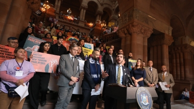 Senator Andrew Gounardes joins immigration advocates at a rally in support of the New York for All Act.