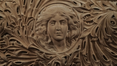 Stone relief of women in Senate Chamber.