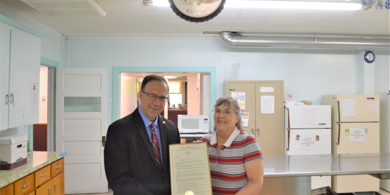 Sen. Joseph Griffo presents a Senate Resolution to Anita Thibado with the Loaves & Fishes Hospitality Center in Canastota