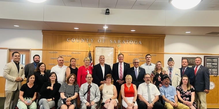 Group shot of Tedisco, Assemblywoman Mary Beth Walsh, Assemblyman Matt Simpson, Saratoga County Clerk Craig Hayner, District Attorney Karen Heggen, Saratoga Veterans Services Director Frank McClement, Saratoga County Board of Supervisors Chairman Todd Kusnierz and Galway Supervisor Mike Smith with Matousek's family Sen. Tedisco, Saratoga County Honor Edinburg U.S. Army Veteran Who Survived Atomic Bomb Testing in the 1950s