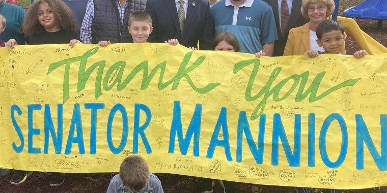 Senator Mannion with various elected officials and children at Lewis Park presenting a large check.