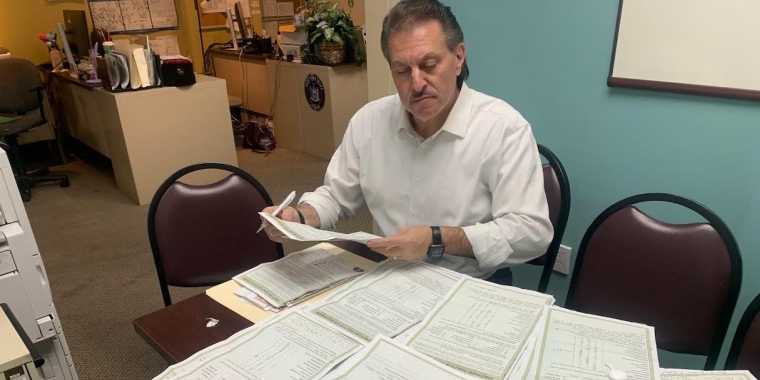 Senator Addabbo looks through the many constituent questionnaires that have come to his offices.