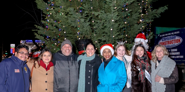 The guests of honor pose in front of the 30-ft tree at the Third Annual Port Richmond Holiday Tree Lighting on Tuesday, Dec. 12, 2023. (Staten Island Advance/Jason Paderon