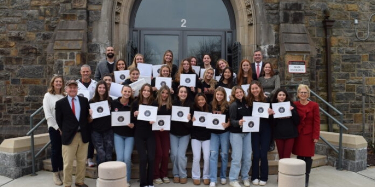 (PHOTO: The champion Rye High School Girls Varsity Soccer team received New York State Assembly proclamations on Thursday, December 14, 2023. Photo shows (most of) the team, Coach Rich Savage, Assistant Coach Giuliana Addesso, Superintendent Dr. Byrne, Principal Suzanne Short, Athletic Director Susan Reid Dullea, and Al Mercado, Assistant to the Athletic Program, along with State Senator Shelley Mayer and State Representative Steve Otis.)