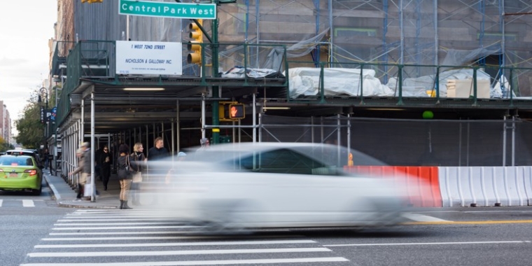 An image of a car speeding down Central Park West.