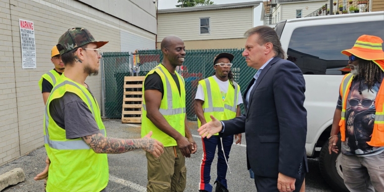 Senator Addabbo shakes hands with the CEO cleaning crew.