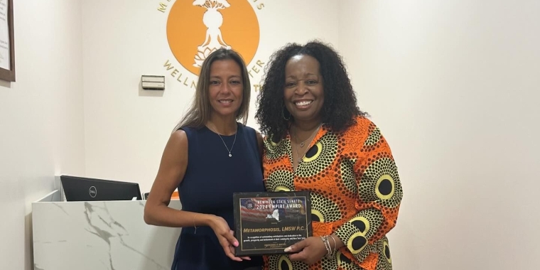 Senator Monica R. Martinez presents the New York State Senate Empire Award to Cheryl Mchunguzi, owner of Metamorphosis Wellness Center.