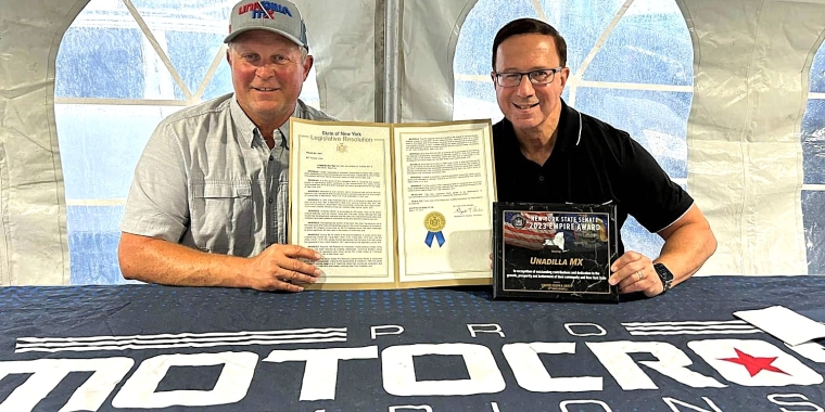 Sen. Joseph Griffo presents a New York State Senate Resolution and Empire Award to Unadilla MX co-owner Greg Robinson