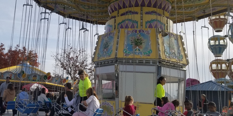 Photo of Adventureland's Wave Swing being loaded with riders.