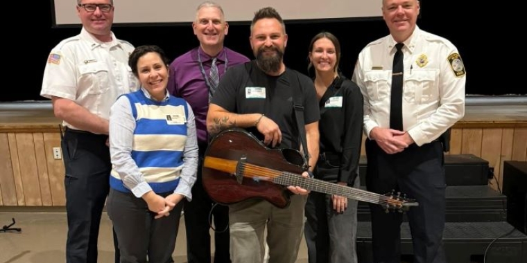 Singer Jared Campbell (center) with members of Senator James Skoufis's staff and Port Jervis Chief William Worden.