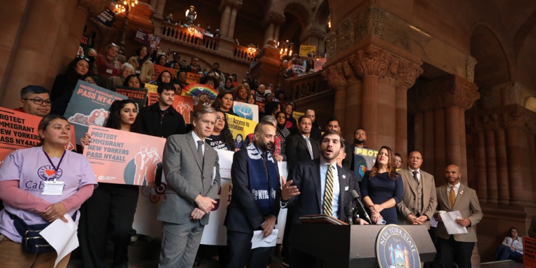 Senator Andrew Gounardes joins immigration advocates at a rally in support of the New York for All Act.