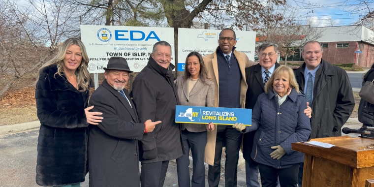 Photo: Representatives from New York State, Suffolk County and the Town of Islip hold sign that reads "Revitalizing Long Island" during a press conference to announce the completion of the Carleton Avenue sewer expansion project.