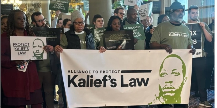 Photo of Sen Cleare with actvisits and banner reading "Kalief's Law" 