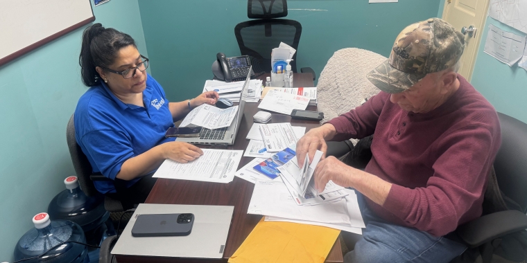 Raiza Martinez of NHSQ provides tax lien assistance to a constituent at Senator Addabbo's Office.