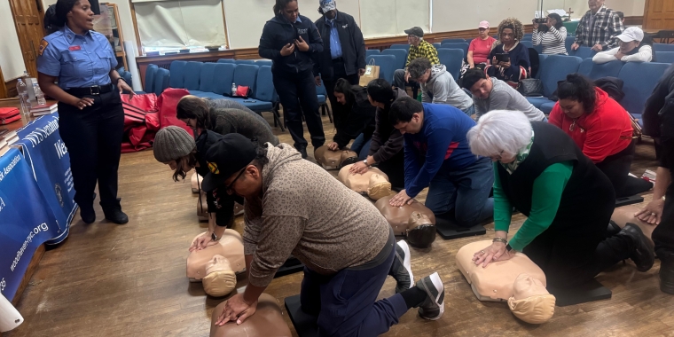 Diana Wilson, an instructor with the FDNY Mobile CPR Training Unit, teaches participants how to do chest compressions.