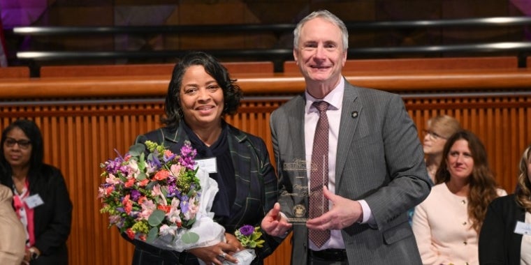 Senator Sean Ryan presents Dr. Marie Cannon with a 2025 Women of Distinction Award