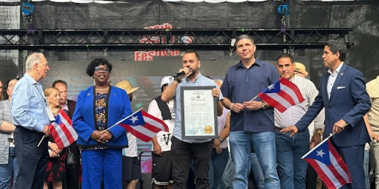 Senator Serrano at the 116th Street Festival with a Proclamation
