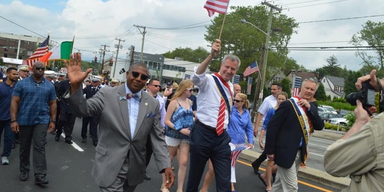 Senator James Sanders Jr. marches alongside NYC Mayor Bill de Blasio at the Little Neck-Douglaston Memorial Day Parade.