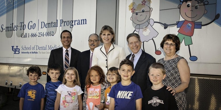 Dr. Stephen Abel, Associate Dean for Student, Community and Professional Initiatives, University at Buffalo; Dr. Joseph Zambon, Dean, University at Buffalo School of Dental Medicine; Senator Catharine Young; Tim Mains, Superintendent, Jamestown City School District; and Paula Fisher, Project Coordinator, Rural Dentistry Program, University at Buffalo School of Dental Medicine join students who received care through the Rural Dentistry Pilot Program.