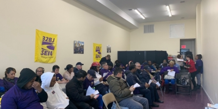 Airport workers & members of 32BJ SEIU attend a presentation