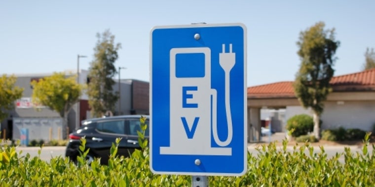 Sign showing an electric vehicle charging station Sign showing electric vehicle charging station