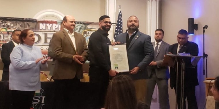 Senator Kevin Thomas presents NYPD Det. Sumit Sulan with a Proclamation Recognizing his bravery and heroic actions.
