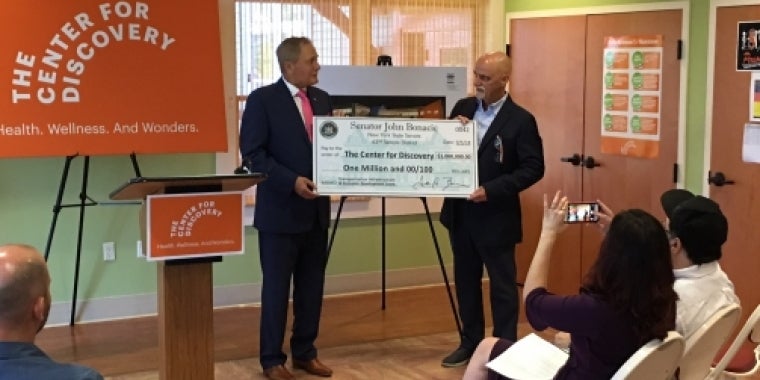 Senator Bonacic presents a ceremonial $1 million check to Patrick Dollard