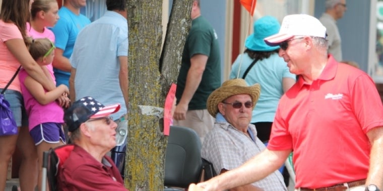 Senator Ranzenhofer talks to residents as he walks down the sidelines of the parade.