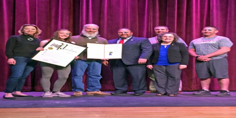 At the May 9 tribute in the Dundee Junior-Senior High School auditorium, from left to right: Macy Hall (Lily’s mother), Lily, William Hall (Lily's father), Assemblyman Palmesano, Varsity Boys’ Track Coach Scott Shepardson, Sharon Sitrin-Moore, and Varsity Girls’ Track Coach Joe Hober.