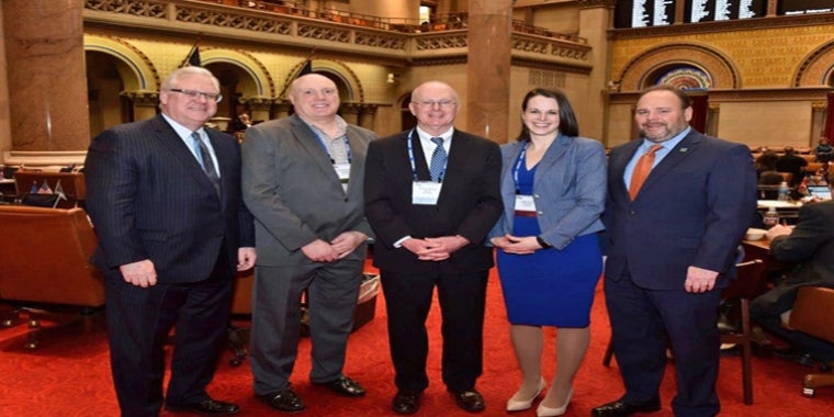 In the photo above in the state Assembly Chamber, from left to right: Senator O’Mara, Corning City Manager Mark Ryckman, Corning Mayor Bill Boland, Corning City Councilmember Alison Hunt, and Assemblyman Palmesano. In the photo above in the state Assembly Chamber, from left to right: Senator O’Mara, Corning City Manager Mark Ryckman, Corning Mayor Bill Boland, Corning City Councilmember Alison Hunt, and Assemblyman Palmesano.