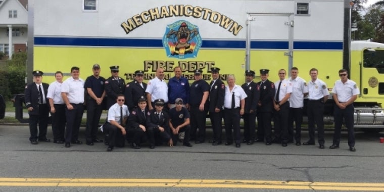 Senator Bonacic (blue jacket), who is an honorary member of Mechanicstown Fire Department, is pictured with several of its members.