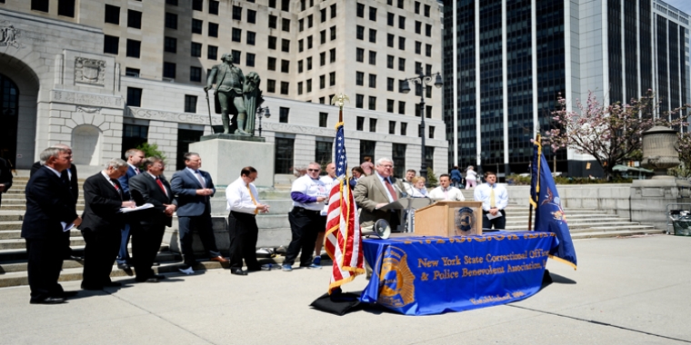 Senator O'Mara addresses today's rally flanked by legislative colleagues, NYSCOPBA representatives and other supporters in Albany's West Capitol Park.