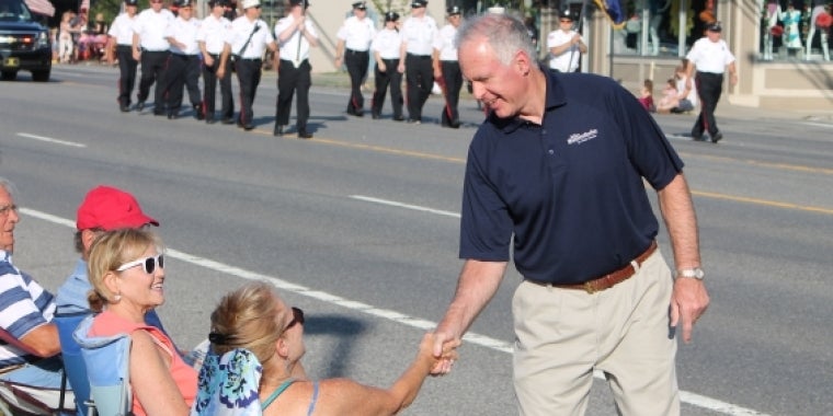 Senator Ranzenhofer shakes hands with residents along the parade route on Main Street.