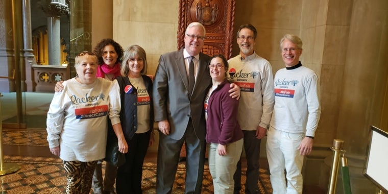 In the photo above at the State Capitol, from left to right: Karla Kesel (Direct Support Professional), Nancy Corwin Malina (President, Board of Directors), Perri LoPinto (Director of Donor & Government Relations), Senator O’Mara, Annie Joyce, Lanny Joyce, and Dan Brown (Executive Director). In the photo above at the State Capitol, from left to right: Karla Kesel (Direct Support Professional), Nancy Corwin Malina (President, Board of Directors), Perri LoPinto (Director of Donor & Government Relations), Senator O’Mara, Annie Joyce, Lanny Joyce, and Dan Brown (Executive Director).