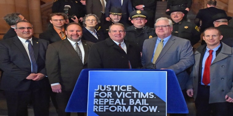 Local participants at Tuesday’s rally, front row, l. to r.: Assemblyman Joseph Giglio, Assemblyman Phil Palmesano, Steuben County District Attorney Brooks Baker, Senator Tom O’Mara, Hornell Mayor John Buckley. Back row, l. to r.: Assemblyman Chris Friend, Assemblywoman Marjorie Byrnes, Steuben County Undersheriff John McNelis, Bath Police Chief Chad Mullen, Steuben County Sheriff James Allard.  local participants at Tuesday’s "Repeal Bail Reform" rally, front row, l. to r.: Assemblyman Joseph Giglio, Assemblyman Phil Palmesano, Steuben County District Attorney Brooks Baker, Senator Tom O’Mara, Hornell Mayor John Buckley. Back row, l. to r.: Assemblyman Chris Friend, Assemblywoman Marjorie Byrnes, Steuben County Undersheriff John McNelis, Bath Police Chief Chad Mullen, Steuben County Sheriff James Allard.