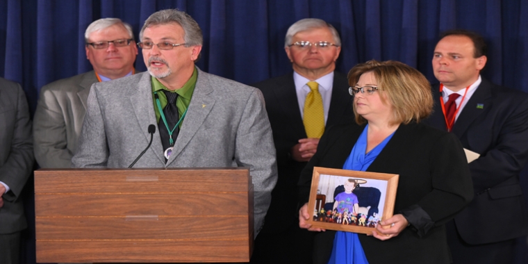 Dale and Dori Robie (holding a photo of her son Derrick) at the Capitol last year calling for the approval of parole reform legislation.