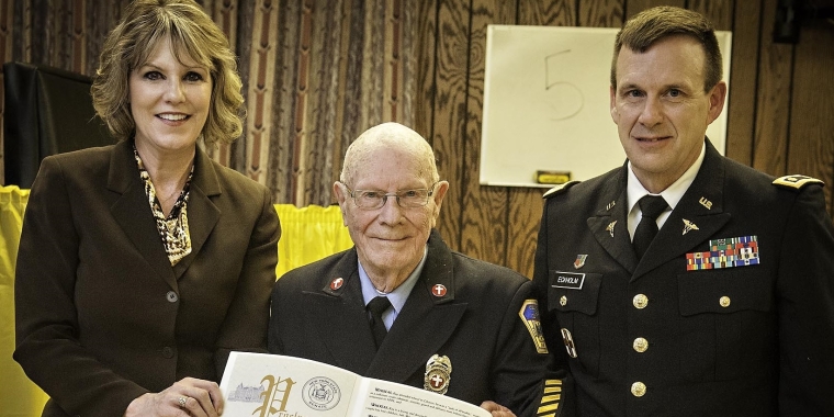 Senator Catharine Young presents Ray Eckholm Jr., with a New York State Senate Proclamation honoring his 65 years of service to Celoron Hose Company No. 1. During the award ceremony, Mr. Eckholm was joined by his son, Major John Eckholm, who was visiting from North Carolina.