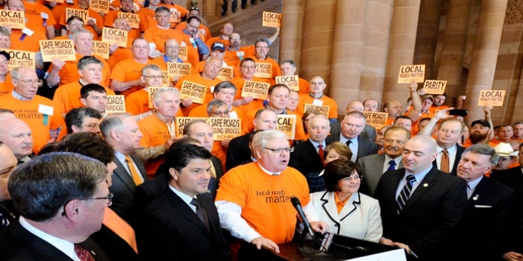 Senator O'Mara addresses this morning's "Local Roads Matter" rally at the Capitol, surrounded by legislative colleagues and local highway superintendents from throughout New York State.