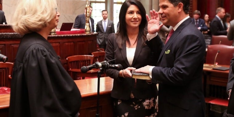 The Honorable Janet DiFiore administers the Oath of Office to Senator George Amedore, as his wife Joelle holds the Bible.